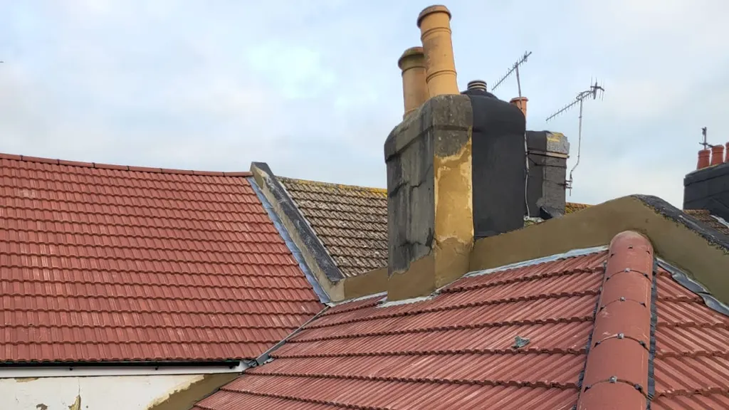 A completed re-roof in new red tiles by Masters Roofing, seen across the ridge line