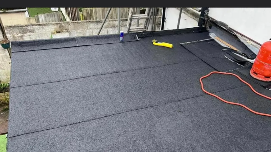 A newly covered flat roof by Masters Roofing, finished in mineral felt across the full deck