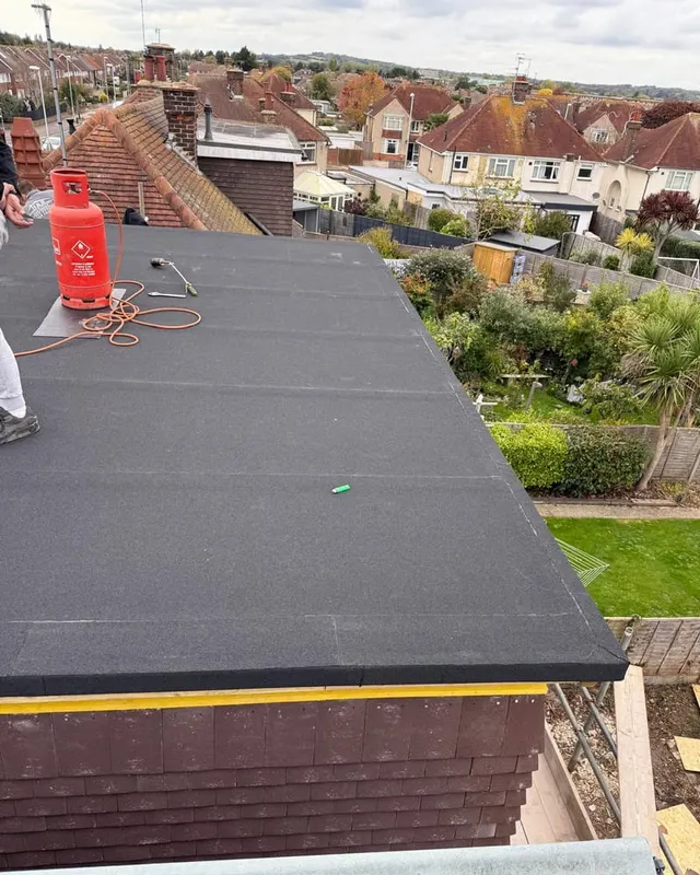 A new torch-on felt flat roof laid over the extension, finished to the abutment and edge trim