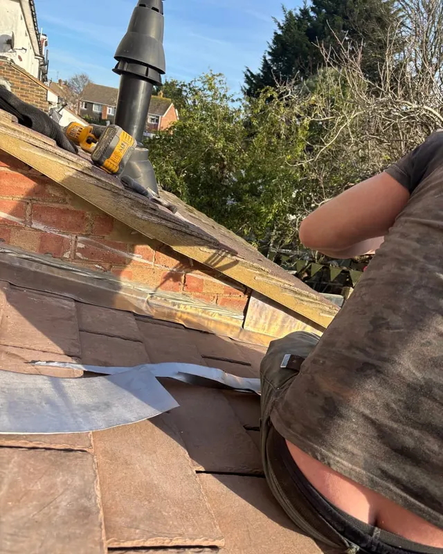 Lead being cut and worked by hand on the bench on site