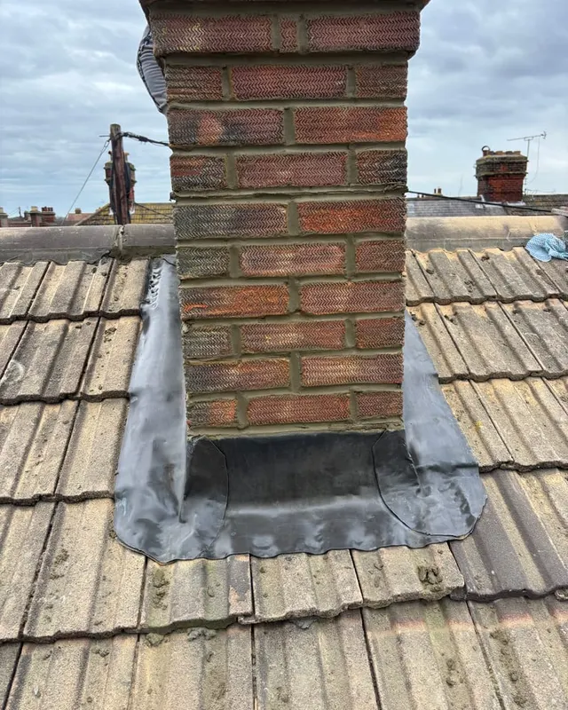 A chimney stack repointed and refitted with new lead soakers and step flashing