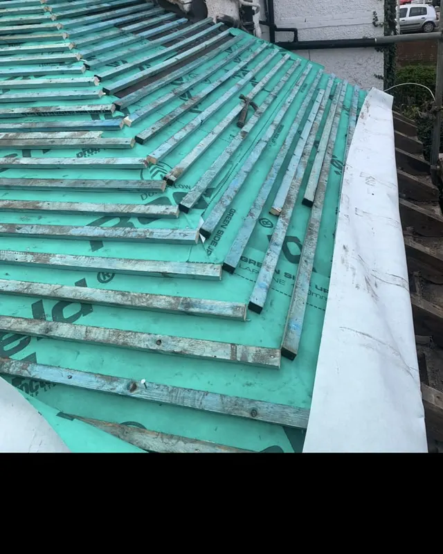 New breathable roofing membrane and treated battens laid across a stripped roof