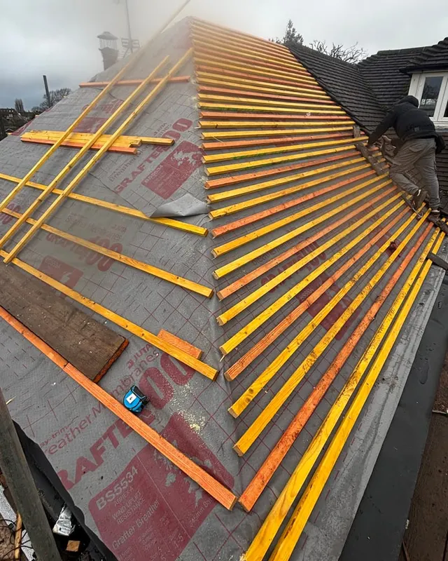 Treated battens set out over breathable membrane, ready for tiling
