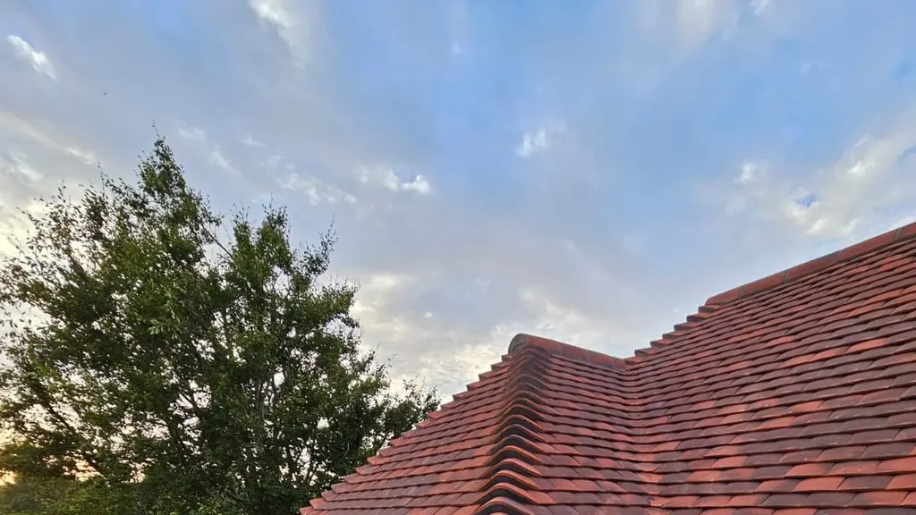 A completed re-roof by Masters Roofing against an open Sussex sky