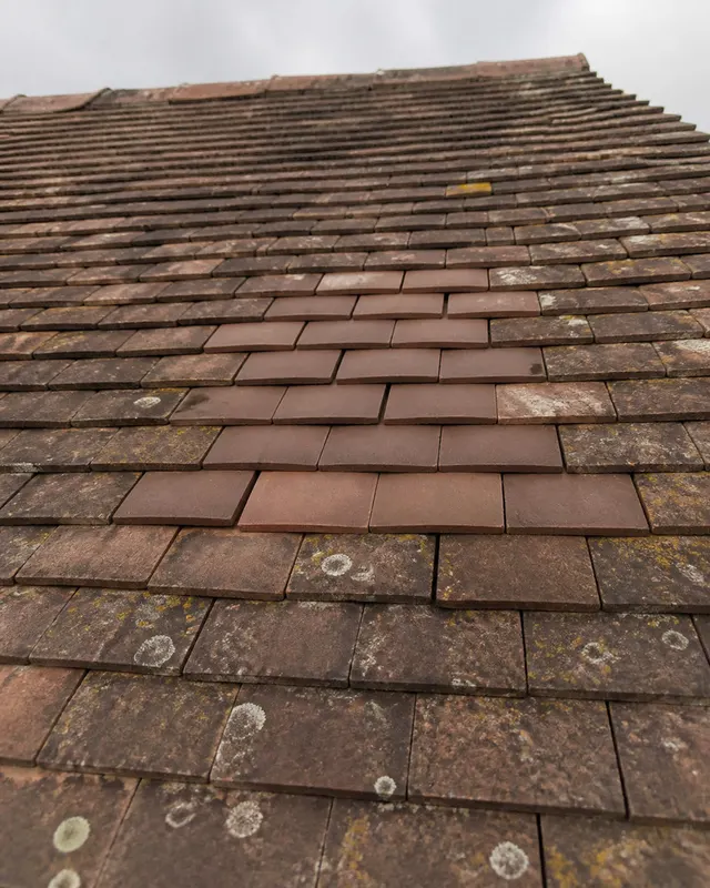 Replacement roof tiles bedded into a pitched roof after storm damage on a property in BN18