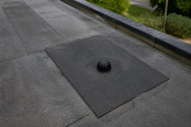 Repaired flat roof section with new capping sheet bonded around the outlet on a property in BN42