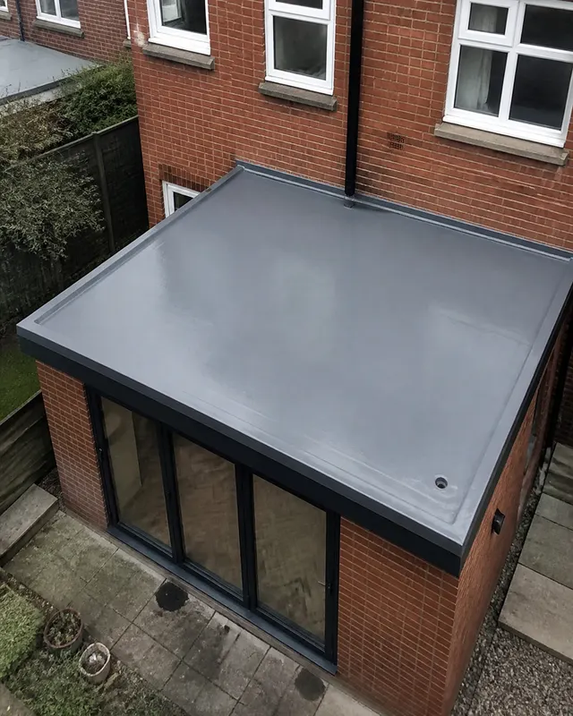 Newly installed GRP fibreglass flat roof with trimmed edges and a seamless finish on a rear extension in Worthing