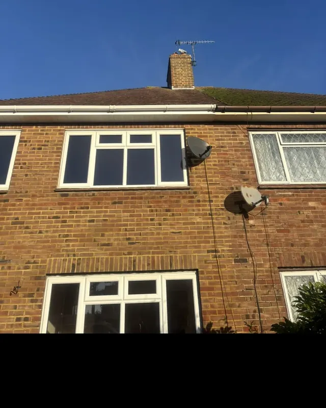 The same elevation before work, with the original eaves, tired guttering and a moss-covered roof