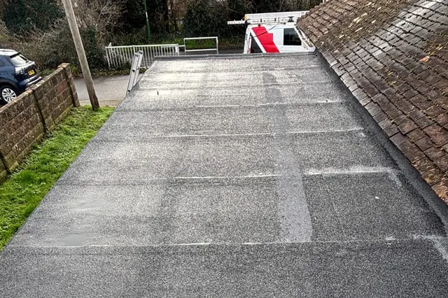 A repaired and re-covered flat roof by Masters Roofing, finished in new mineral felt with a clean edge detail
