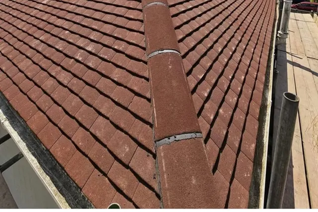 A completed full re-roof by Masters Roofing, showing new interlocking tiles running up to a new ridge across the full hip