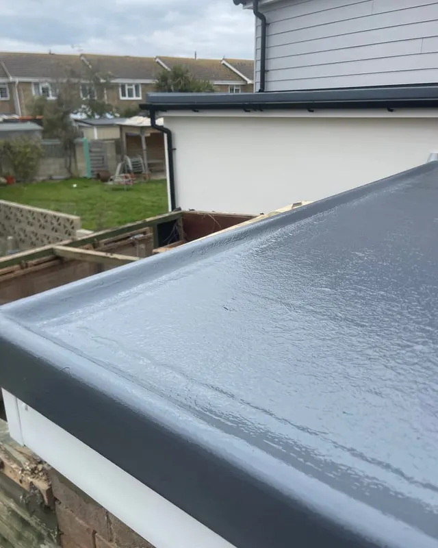 A completed GRP fibreglass flat roof by Masters Roofing, seamless from the deck up to the rendered upstand