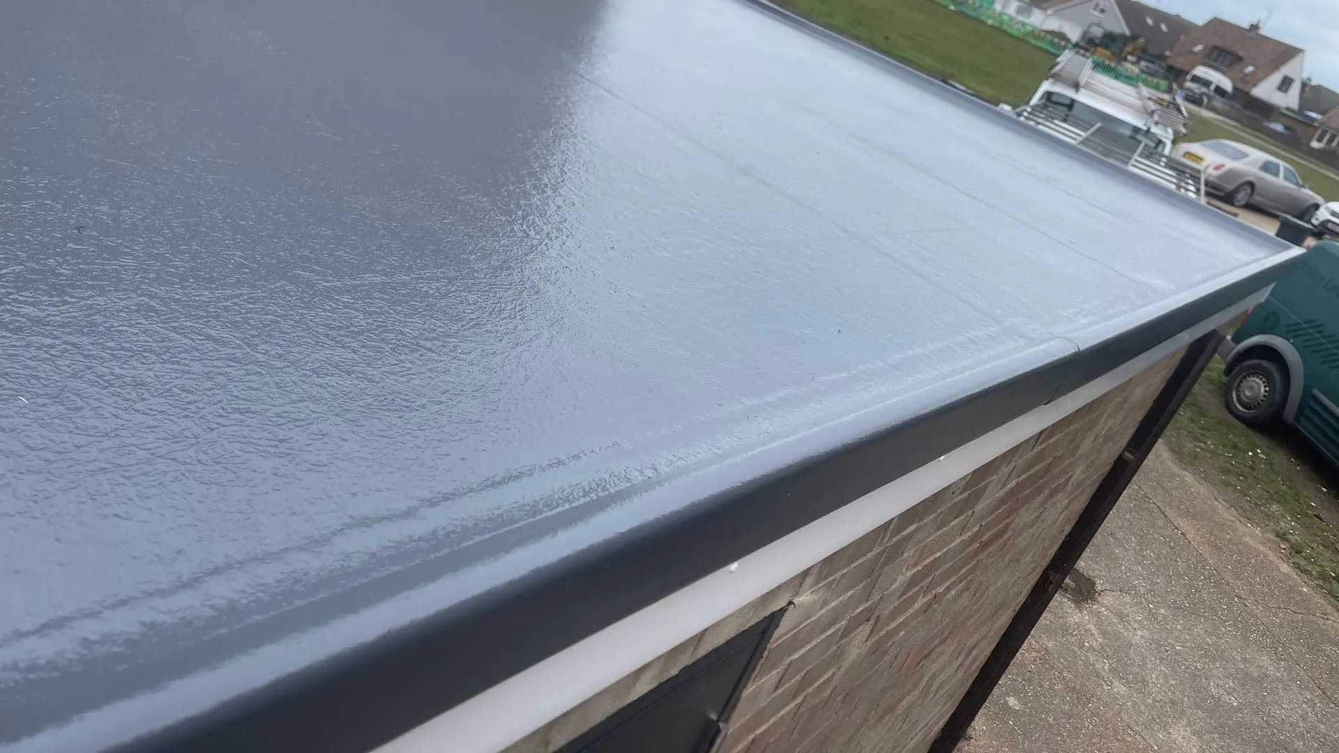A completed GRP fibreglass roof by Masters Roofing, showing the seamless topcoat running into the GRP drip trim